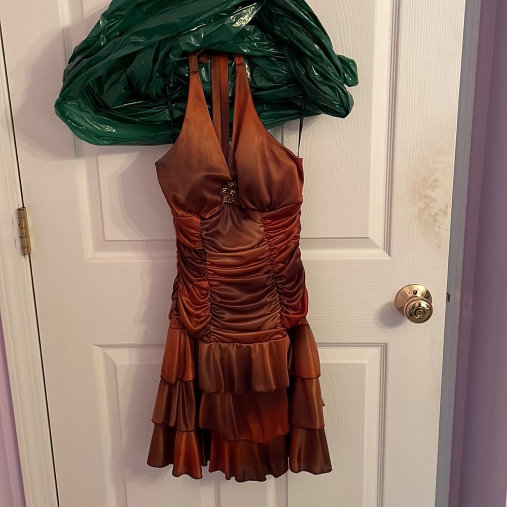 Xoxo size small brown satin halter dress with brooch on front.